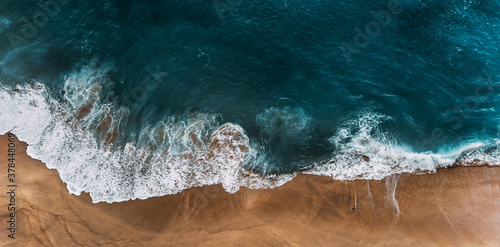 Panorama of a clean beach. Aerial view of the blue ocean waves on the beach. Beautiful sandy beach with blue sea. Lonely sandy beach with beautiful waves. Nusa penida. Copy space