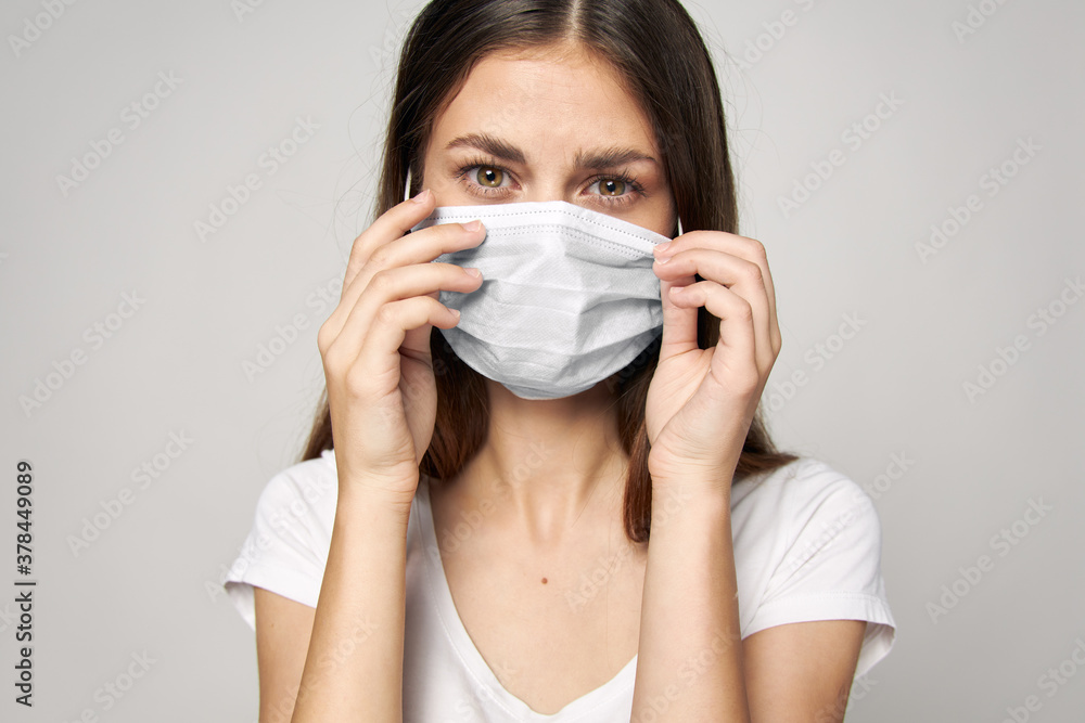 Woman in medical mask on face Look Forward white T-shirt Woman in medical mask on face Look Forward white T-shirt
