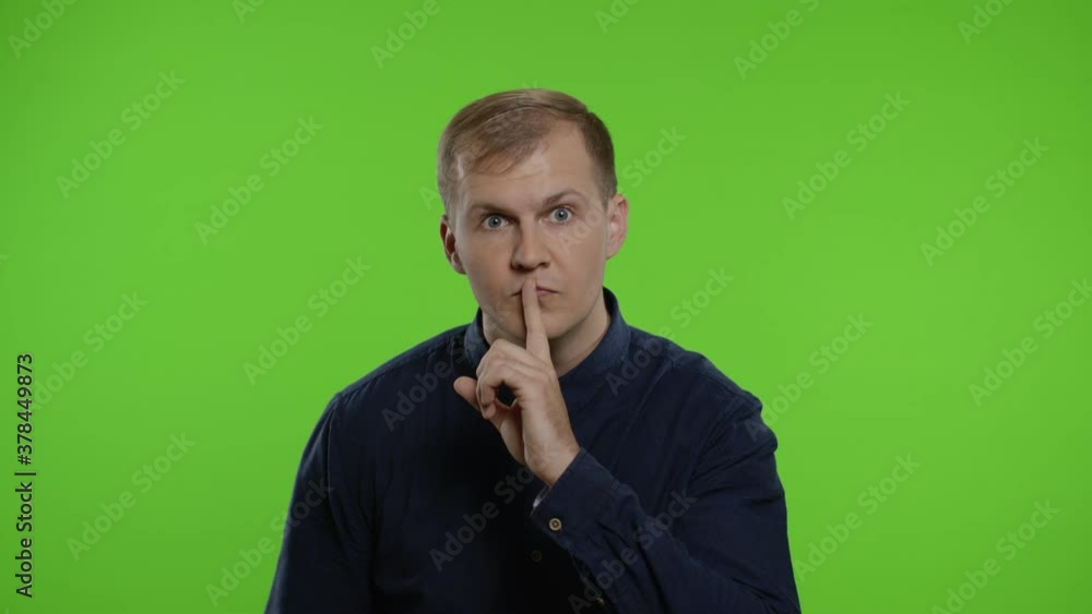 Man showing Black Friday inscription, putting finger on lips making silence gesture. Chroma key Man showing Black Friday inscription, putting finger on lips making silence gesture. Chroma key