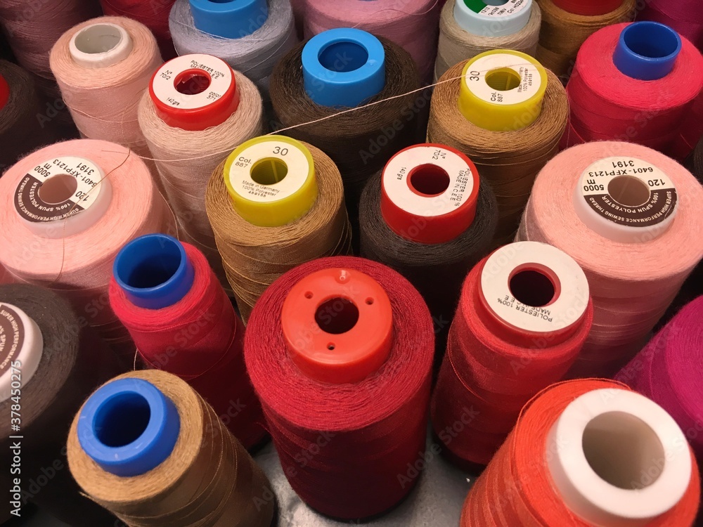 Set of sewing threads of varieties of color red. Threads of shades of red and brown on spools. Sewing materials Set of sewing threads of varieties of color red. Threads of shades of red and brown on spools. Sewing materials