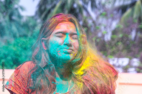 Canvas Print a lady getting showered with holi colours during holi festival in india