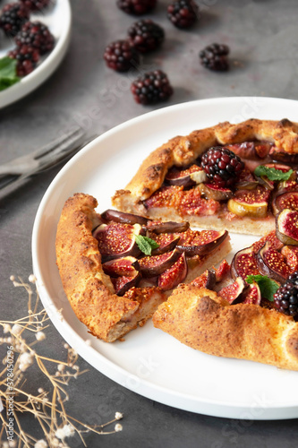 Close up slice of galette with fresh figs. Traditional rustic fruit homemade pie, top view.