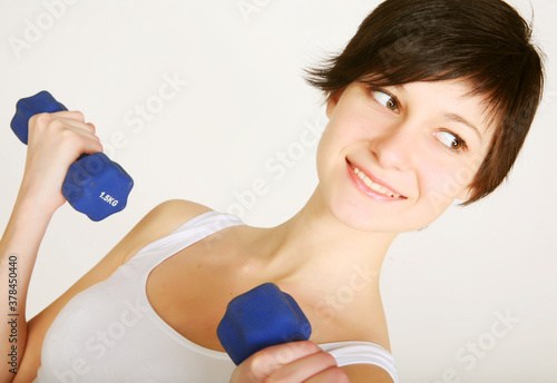 young fitness woman lifting weights photo