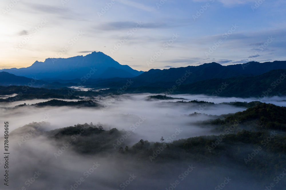 Aerial image of beautiful fresh green nature landscape scene of tropical rainforest and clouds during morning sunrise
