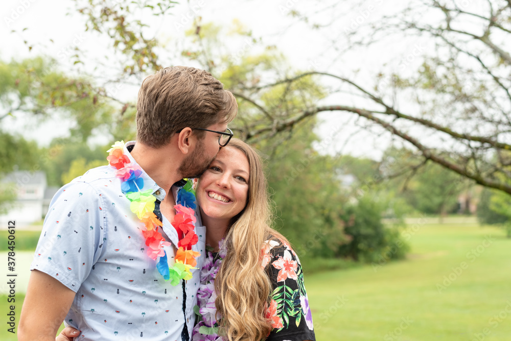 Cute young couple at a Hawaiin theme party Cute young couple at a Hawaiin theme party