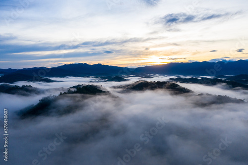 Aerial image of beautiful fresh green nature landscape scene of tropical rainforest and clouds during morning sunrise