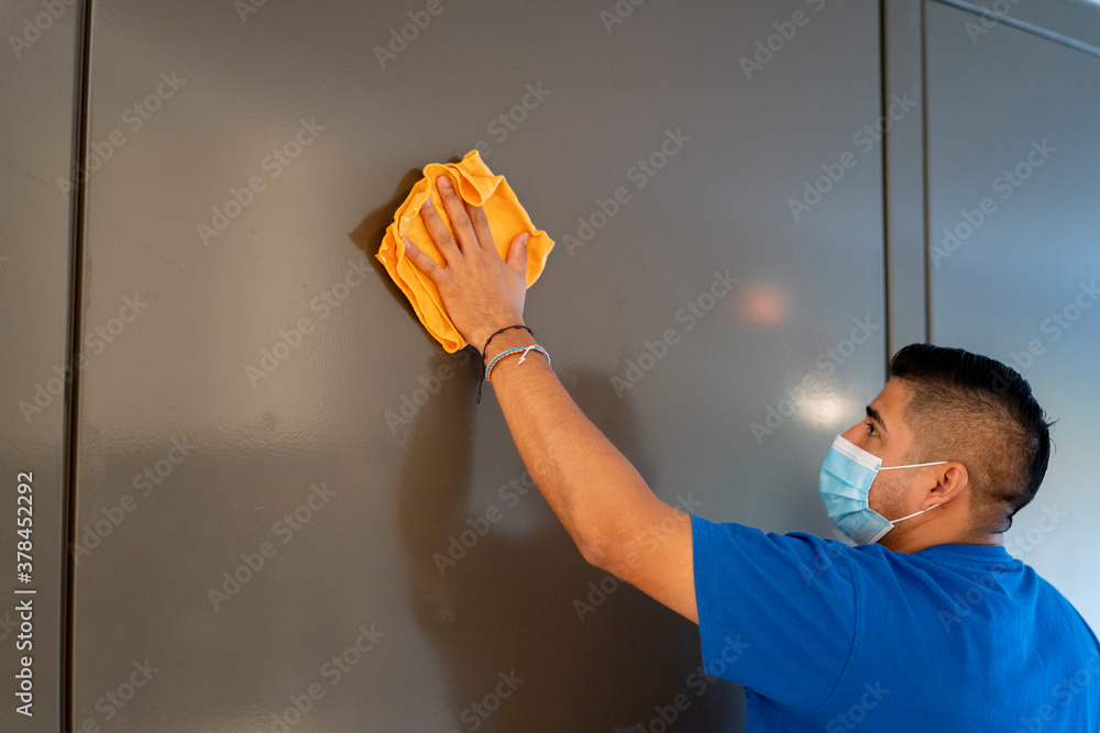 maintenance staff disinfecting hotel walls - obrazy, fototapety, plakaty 