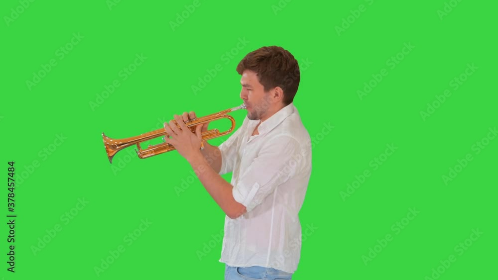 Young musician playing the trumpet on a Green Screen, Chroma Key. Young musician playing the trumpet on a Green Screen, Chroma Key.
