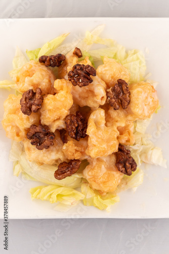 Appetizing plate tempting the tastebuds with Honey Walnut Shrimp in perfect serving size. photo