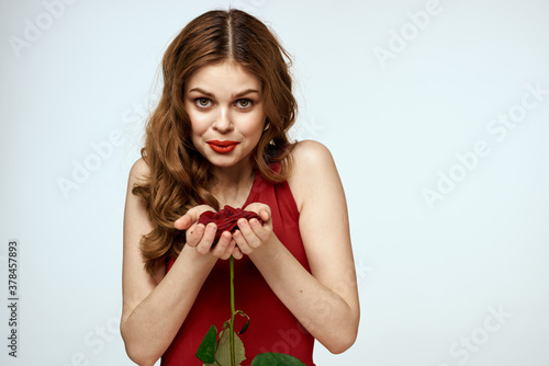 Pretty woman with rose in her hands charm gift lifestyle studio light background © SHOTPRIME STUDIO
