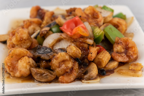 Detail view of appetizing plate tempting the tastebuds with shrimp in black bean sauce in perfect serving size.