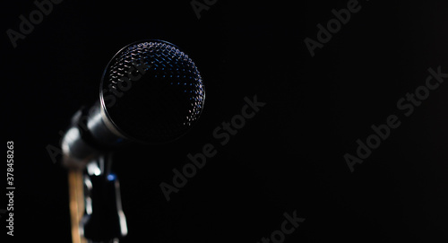 singing mic on a black background with space for text