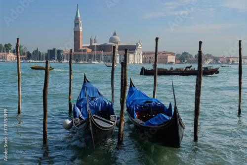 Docked Gondolas and passing boats on Giudecca Canal Venice