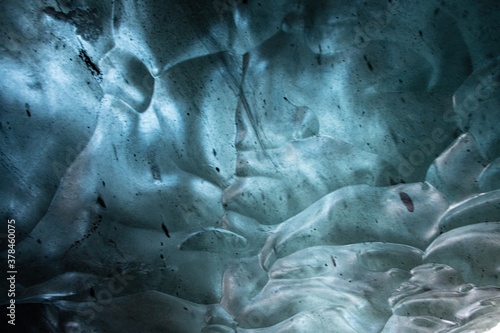 The blue abstract texture in an ice cave in Iceland with air pockets and bubbles. 