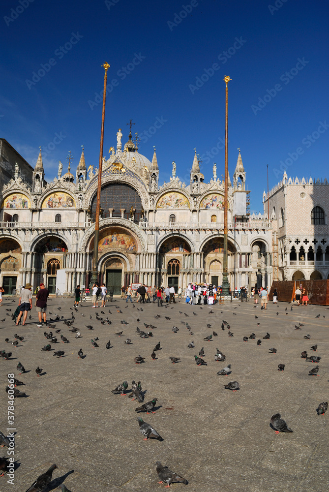Facade of Saint Marks Basilica from the pigeon covered Square in Venice
