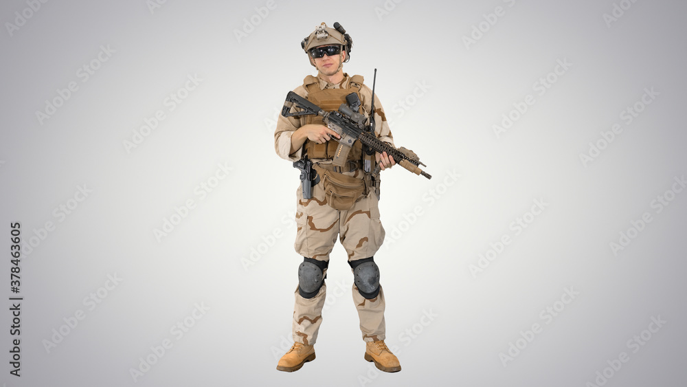 Happy young soldier talking and smiling on gradient background. Happy young soldier talking and smiling on gradient background.
