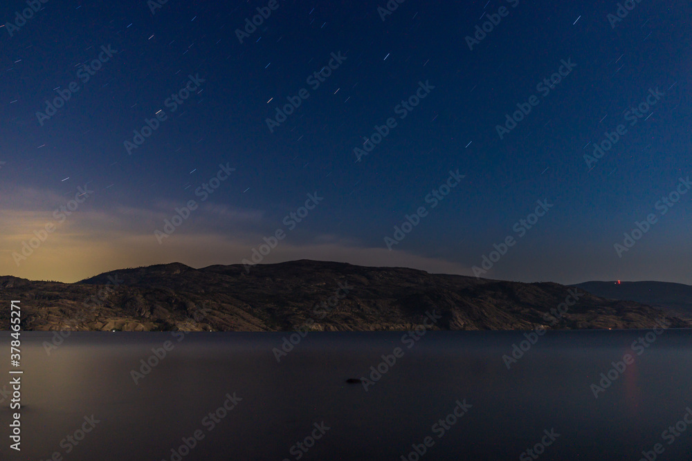 starry sky seen from the shore of Okanagan lake at night british columbia Canada