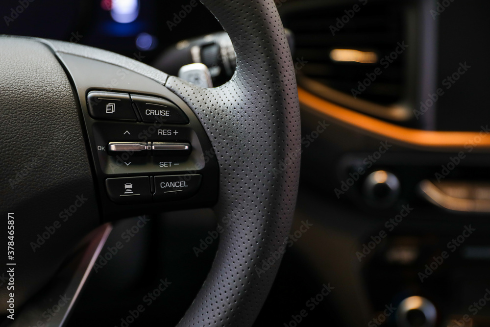 Closeup image of Korean car steering wheel with function buttons