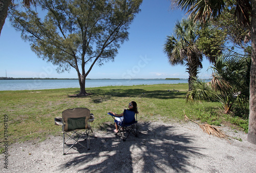 Young girl enjoying tent camping environment n Fort De Soto Park in Pinellas County, Florida.