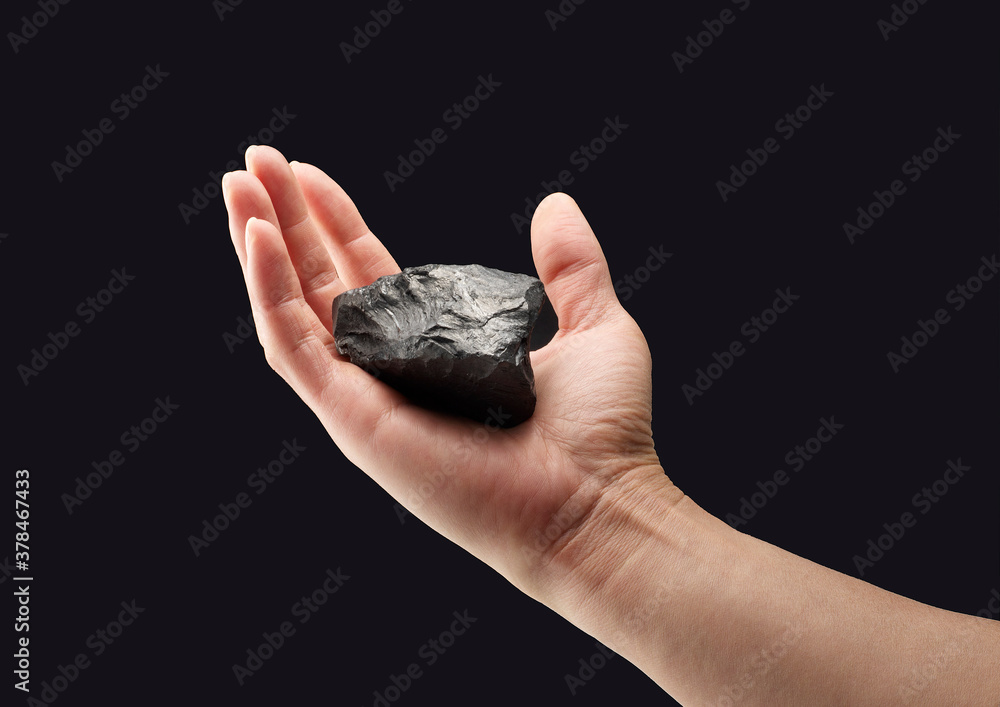 Pieces of coal in hand isolated on white background Pieces of coal in hand isolated on white background