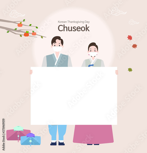 A man and woman couple standing wearing hanbok and masks on Chuseok. The couple is holding a board for signs