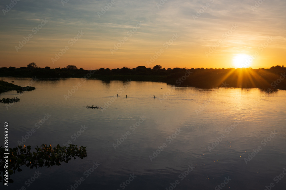 Fototapeta premium Sunset on the banks of the transpantaneira road, in the Pantanal of the State of Mato Grosso close to Pocone, Mato Grosso, Brazil on June 14, 2015.