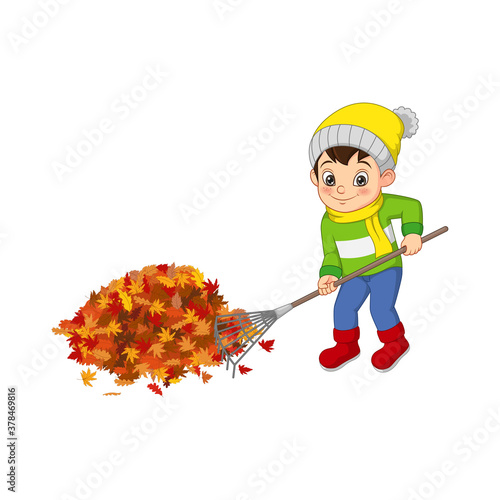 Cute boy volunteers cleaning up autumn leaves