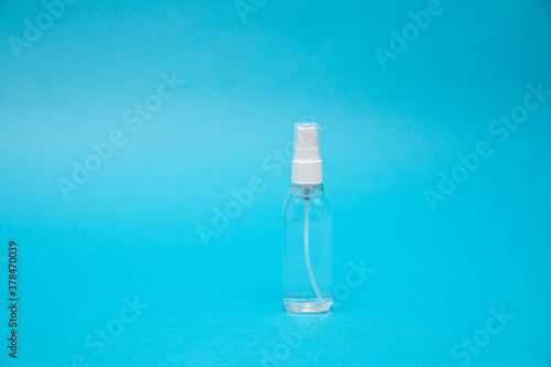 Transparent mist spray bottle on a blue background