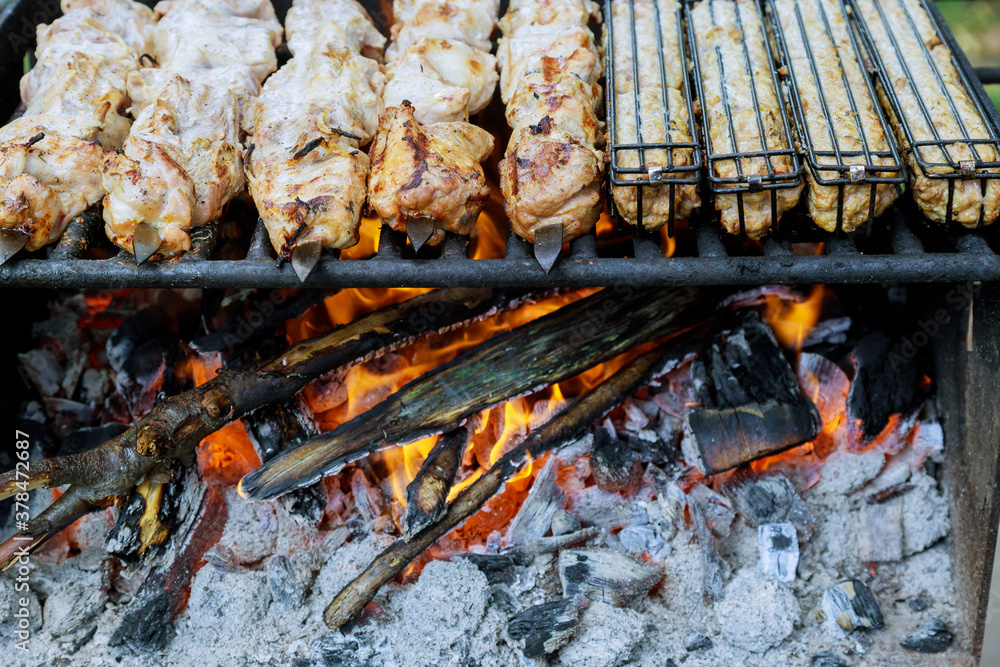 Meat on skewers is grilled with burning charcoal. Meat on skewers is grilled with burning charcoal.