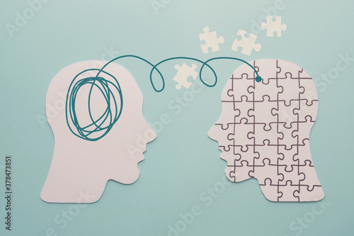 Paper heads and disorder jigsaw puzzle brain, world mental health day, Alzheimer and Psychology concept photo