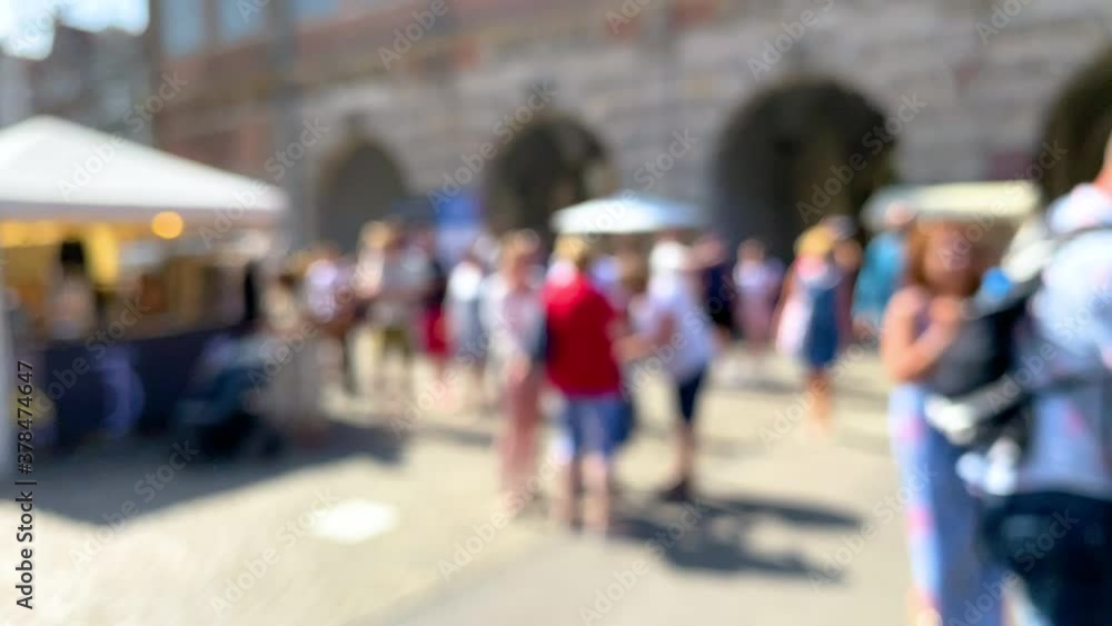 Blurred Shot Of People Strolling Around In Gdansk, Poland On A Sunny Day - defocused, slow motion Blurred Shot Of People Strolling Around In Gdansk, Poland On A Sunny Day - defocused, slow motion