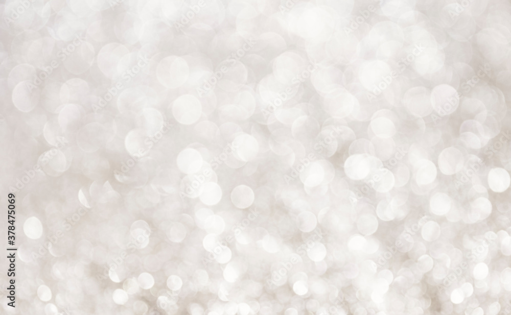 White glitter vintage lights background. Bokeh silver and white. defocused gray background.