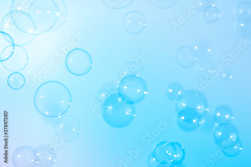 Blue soap bubbles float in the air. Freshness summer natural background.