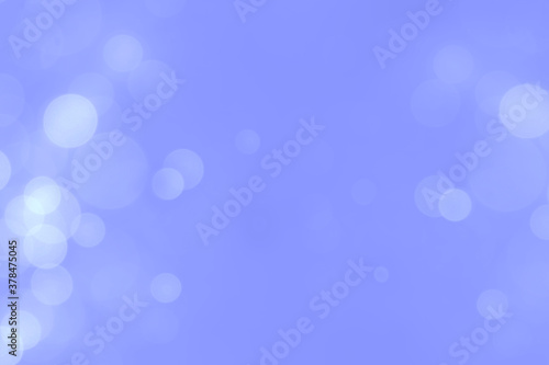 White bokeh lights on violet colour background.
