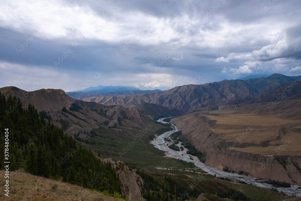 Moutain river valley with sky background. Beautiful wild nature landscape. Adventure travel. Outdoor landscape. Usek river valley in Kazakhstan. Tourism in Kazakhstan concept.