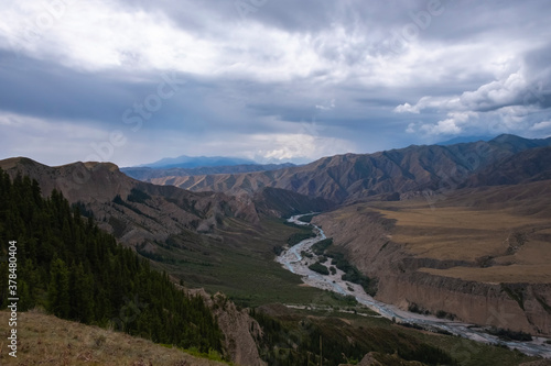 Moutain river valley with sky background. Beautiful wild nature landscape. Adventure travel. Outdoor landscape. Usek river valley in Kazakhstan. Tourism in Kazakhstan concept.