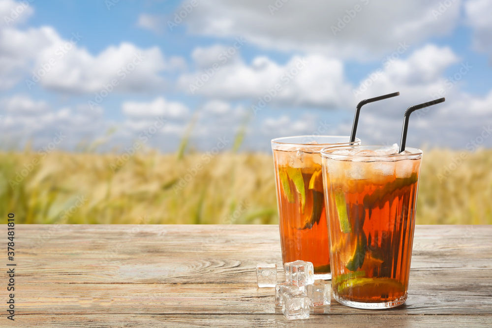Glasses of tasty cold ice tea on table outdoors Glasses of tasty cold ice tea on table outdoors