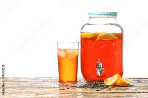 Jar and glass of fresh ice tea on table against white background