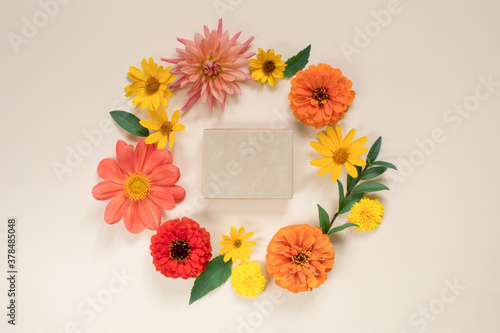 Top view of gift certificate box mock up in the centre of  floral wreath. Holiday background concept.