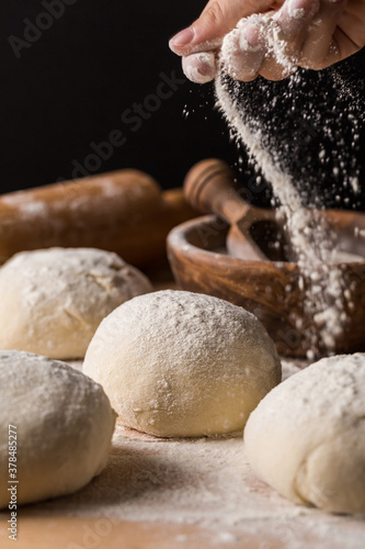 Tablou pe pânză Preparing yeast dough for bread on wooden background.