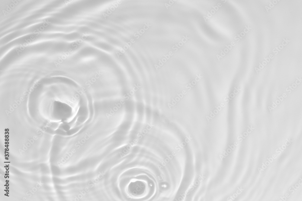 de-focused. Blurred desaturated transparent clear calm water surface texture with splashes and bubbles. Trendy abstract nature background. White-grey water waves in sunlight. Copy space. de-focused. Blurred desaturated transparent clear calm water surface texture with splashes and bubbles. Trendy abstract nature background. White-grey water waves in sunlight. Copy space.