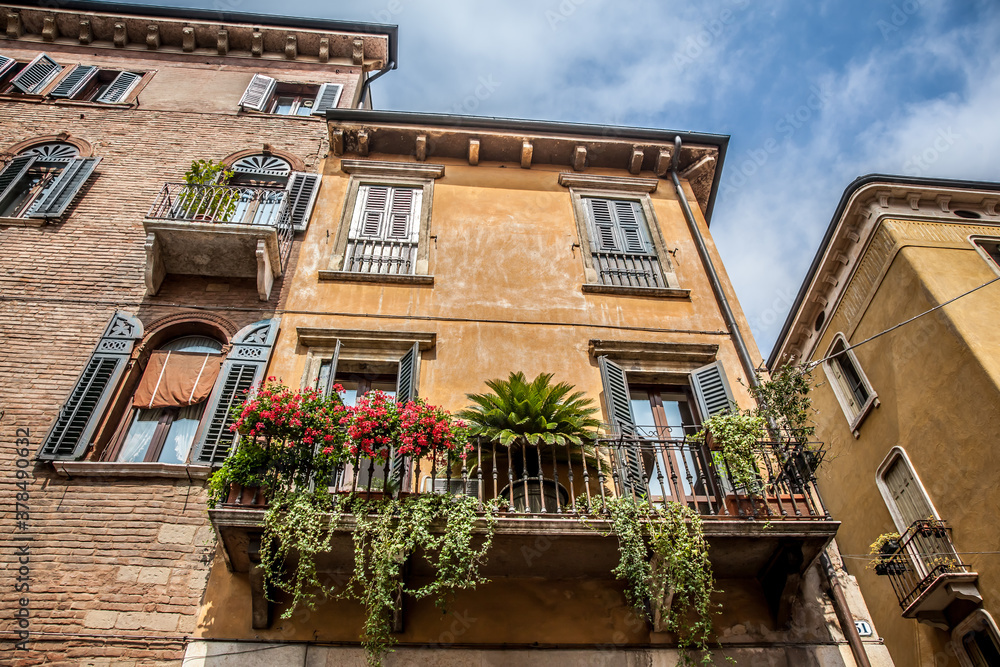 Beautiful balcony decorated with flowers in Verona. Veneto, Italy