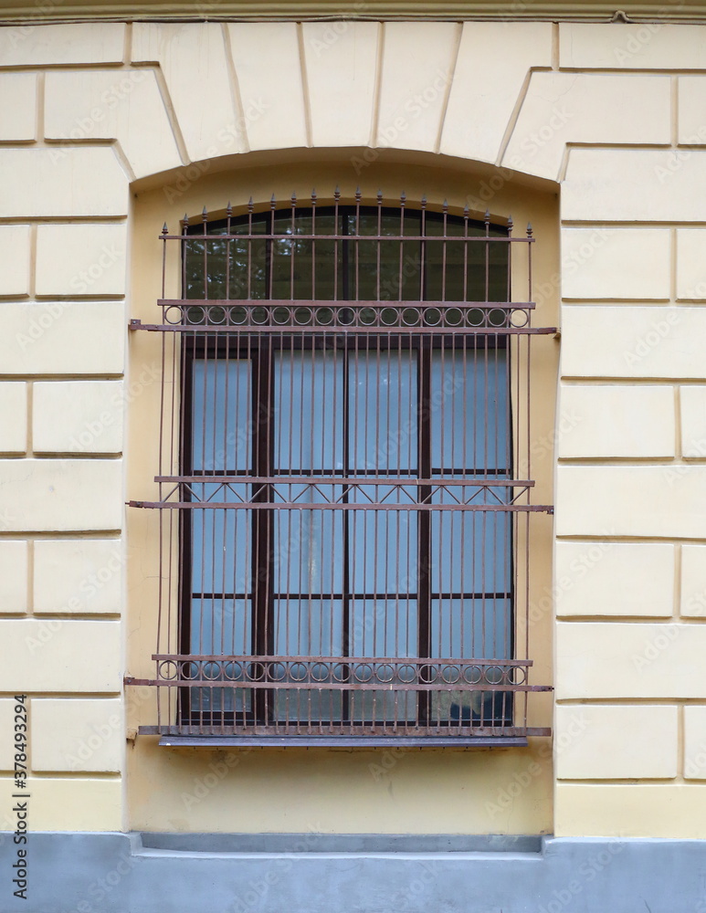 A big window with a metal barrier