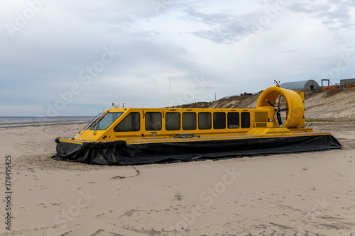 Canvas Print Yellow hovercraft on the sand beach close up