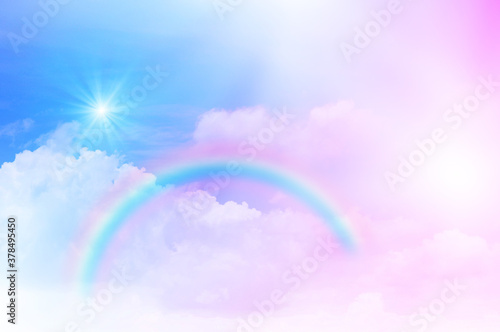 The Rainbow sky is Colorful sky with Soft clouds and a rainbow crossing. Fantasy magical sunny sky pastel background is fluffy white cloud. Freedom wallpaper concept. Sweet color dream. © kikk