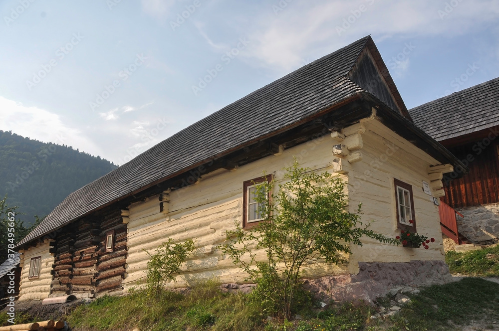 VLKOLINEC, SLOVAKIA, EUROPE, SUMMER 2015. Beautiful rural house with traditional Slovak architecture of vanilla painted wood in the Unesco Heritage village of Vlkolinec. VLKOLINEC, SLOVAKIA, EUROPE, SUMMER 2015. Beautiful rural house with traditional Slovak architecture of vanilla painted wood in the Unesco Heritage village of Vlkolinec.