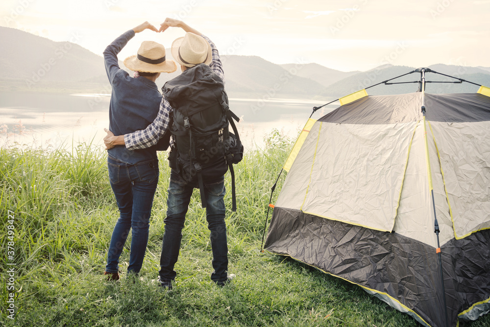Couple travelers with backpacks relaxing mountain nature and enjoying view, freedom and active lifestyle concept.