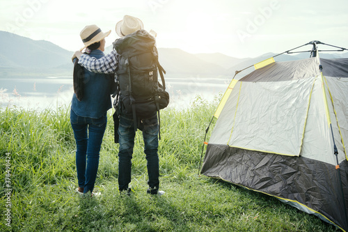 Couple travelers with backpacks relaxing mountain nature and enjoying view, freedom and active lifestyle concept.