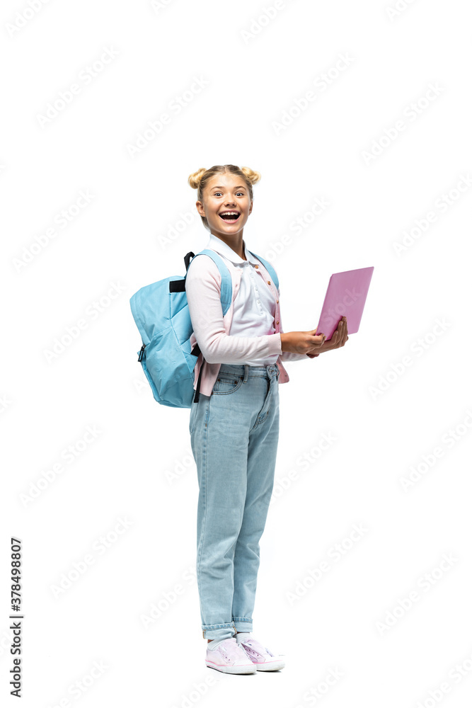 Excited kid with backpack holding laptop on white background Excited kid with backpack holding laptop on white background