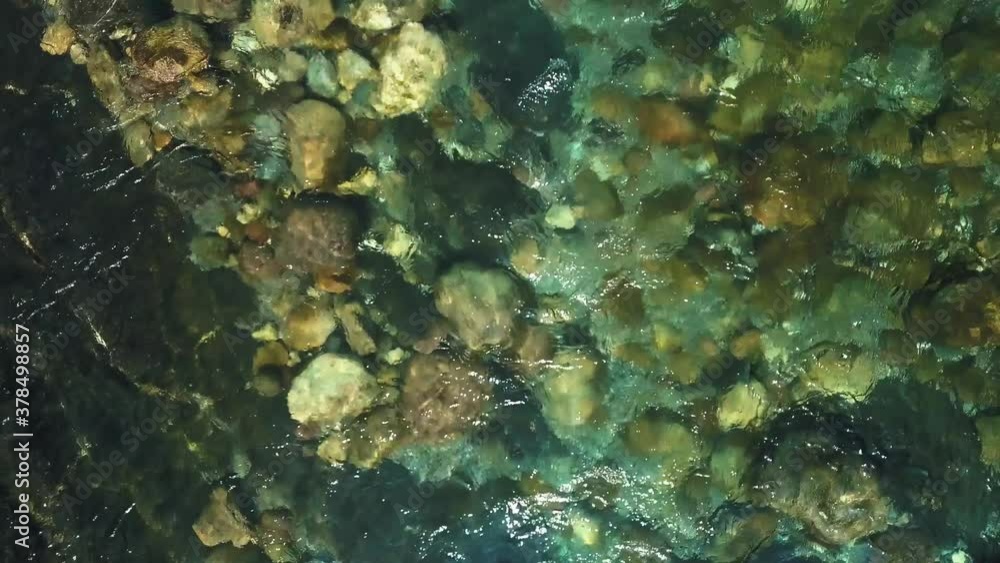 Mountain river with stones at the bottom Mountain river with stones at the bottom